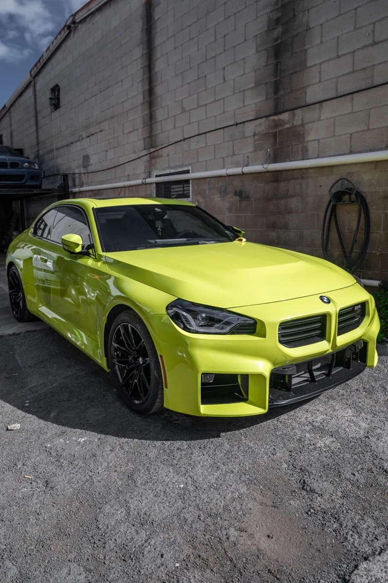 Yellow BMW M2 — Photographed outside the shop, from Fly Garage’s own photo set.