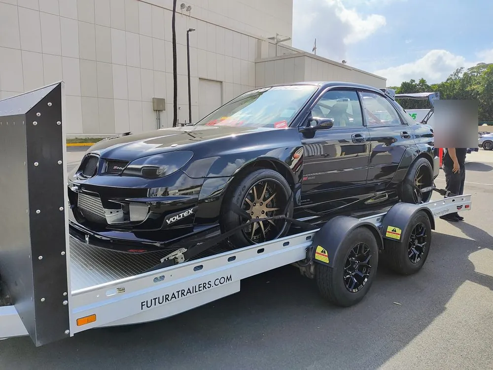 A Subaru WRX secured on the Futura trailer, which lowers to the ground for low cars