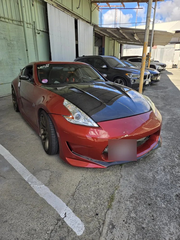 Red 370Z, side view — The same 370Z after its insurance repair, with the carbon hood in place.