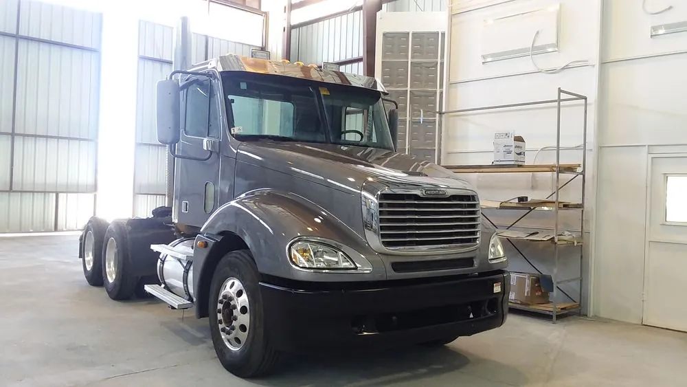 Grey semi truck — A semi-truck tractor in the paint area.