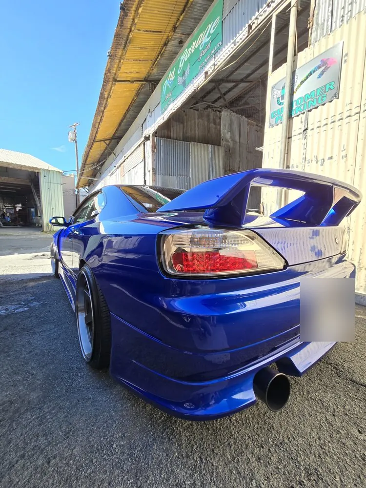 Blue Nissan Silvia S15 — A custom rear spoiler color-matched to the car’s blue paint.