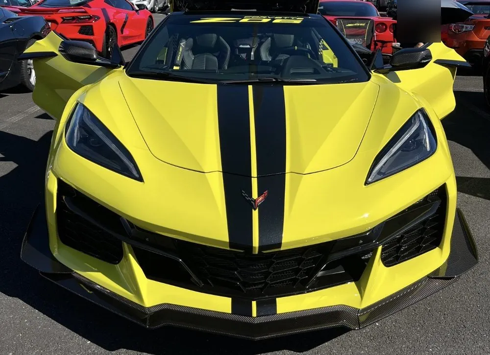 A finished Corvette Z06 in yellow with a black stripe, parked outdoors